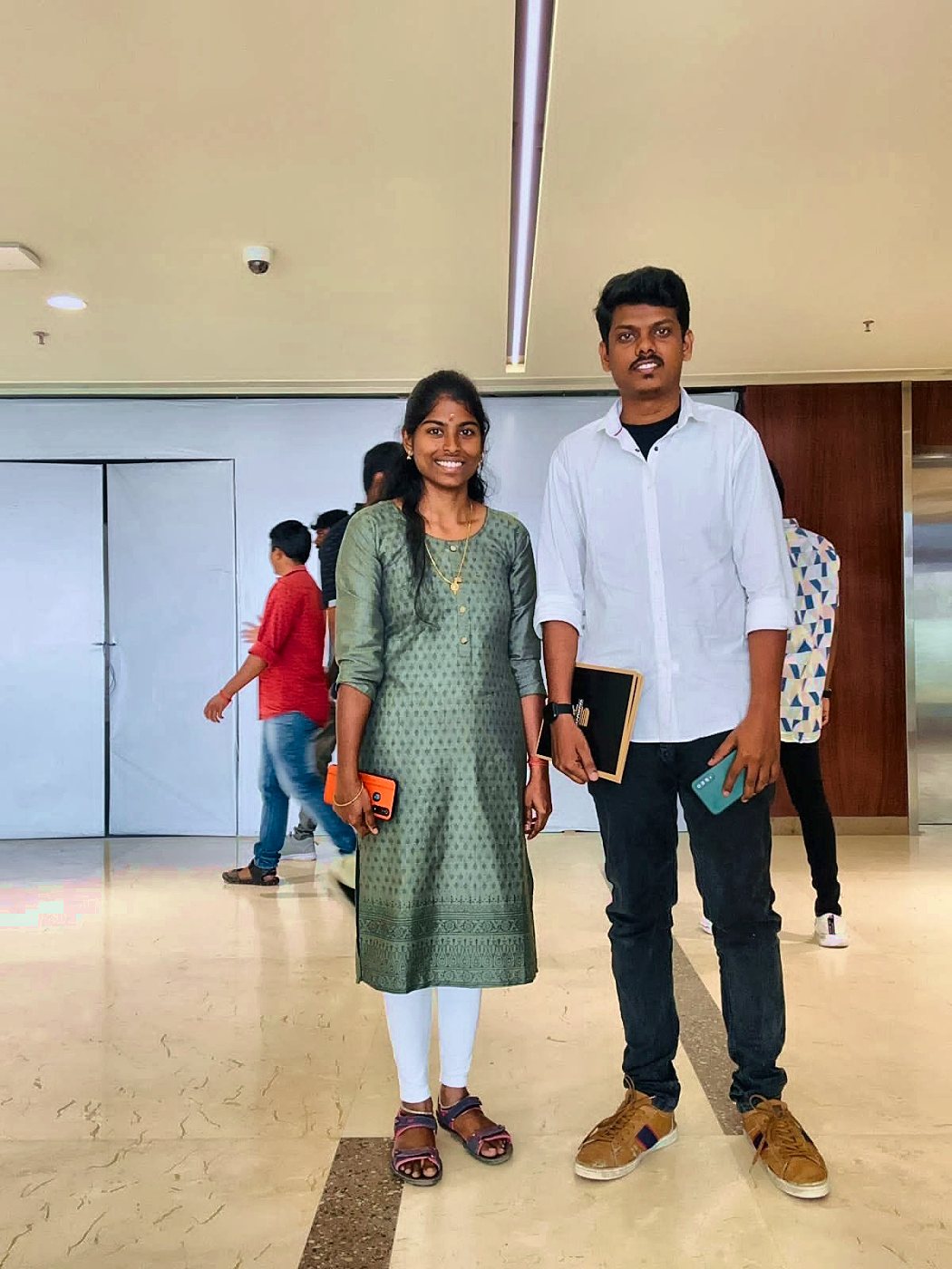Kaviya and Prakash standing together indoors