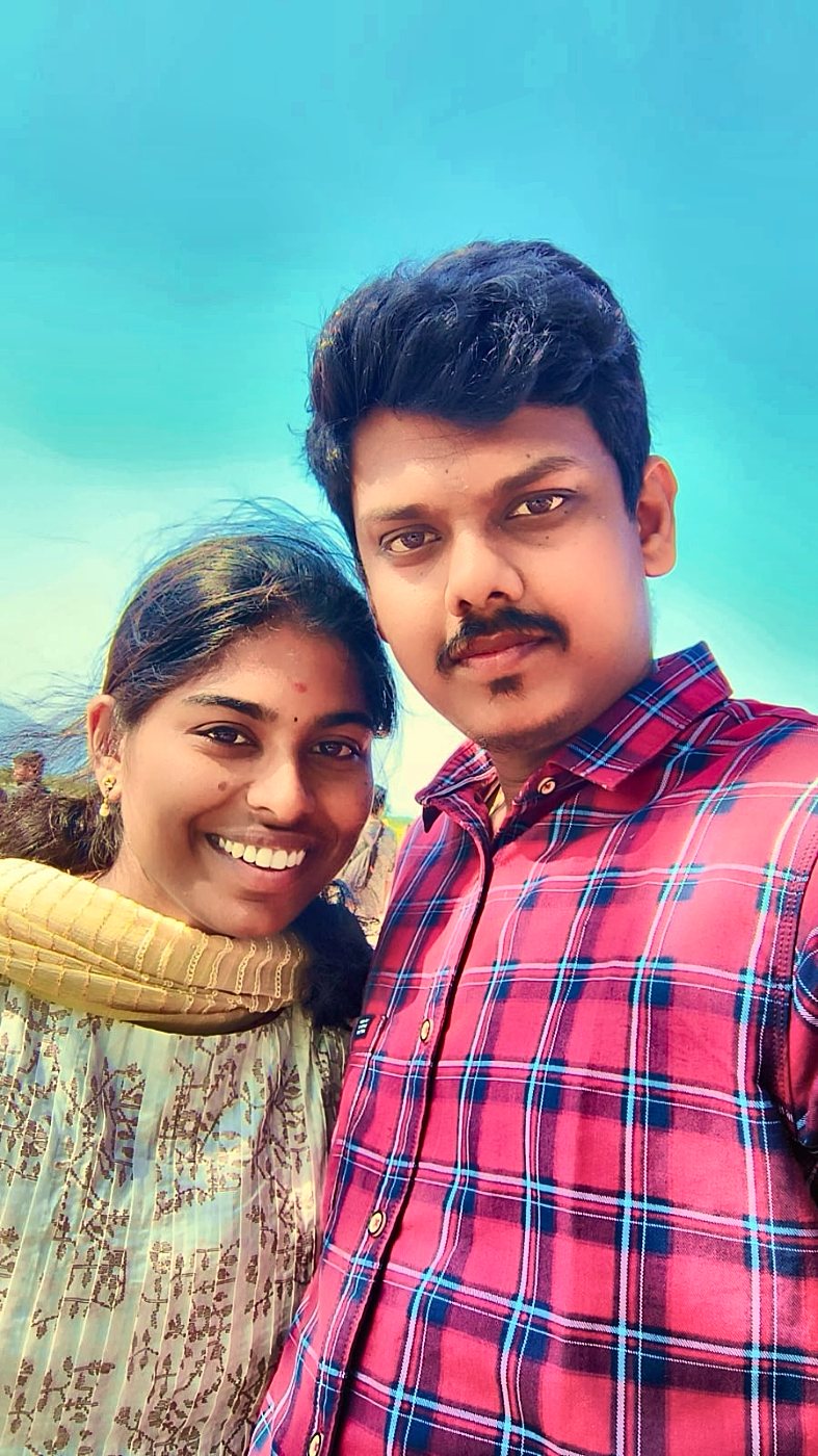Kaviya and Prakash under a blue sky